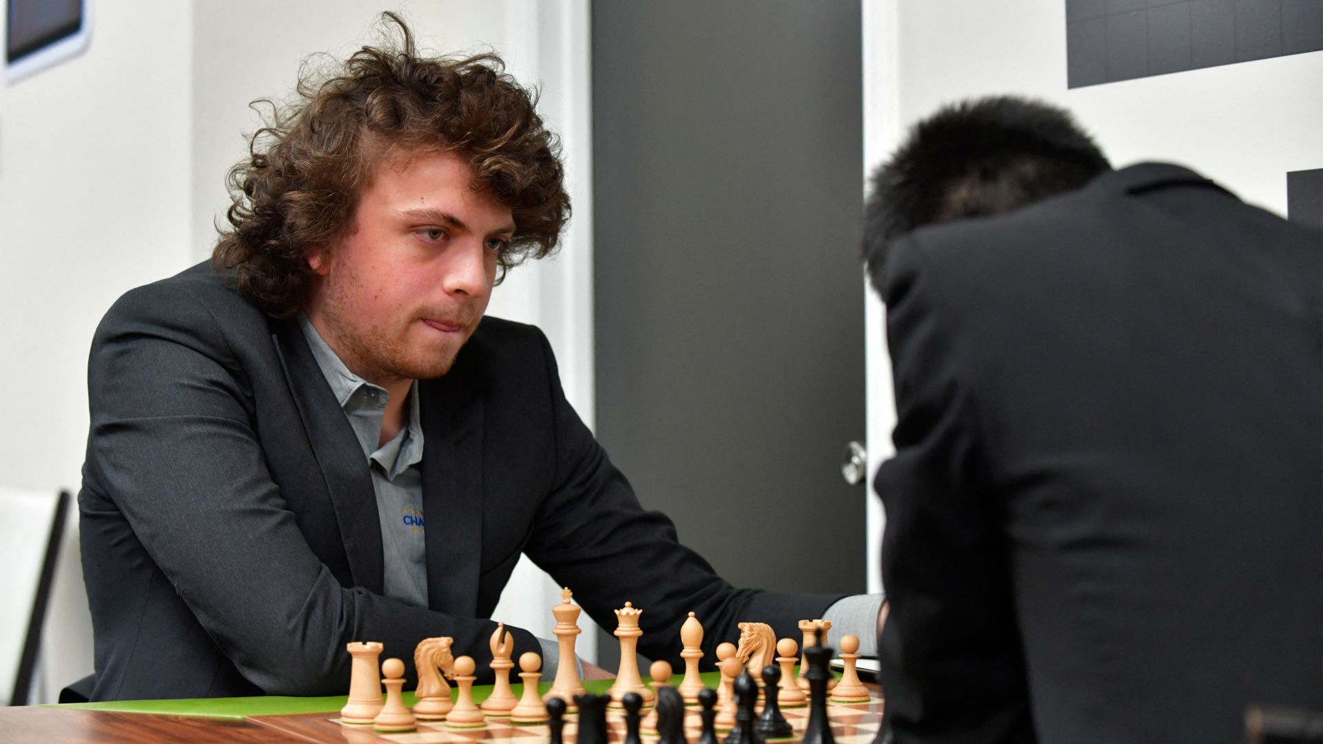 US international grandmaster Hans Niemann waits his turn to move.