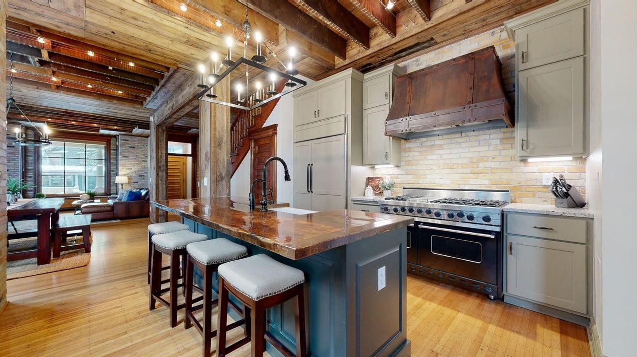 loft-style kitchen with rustic details and modern appliances