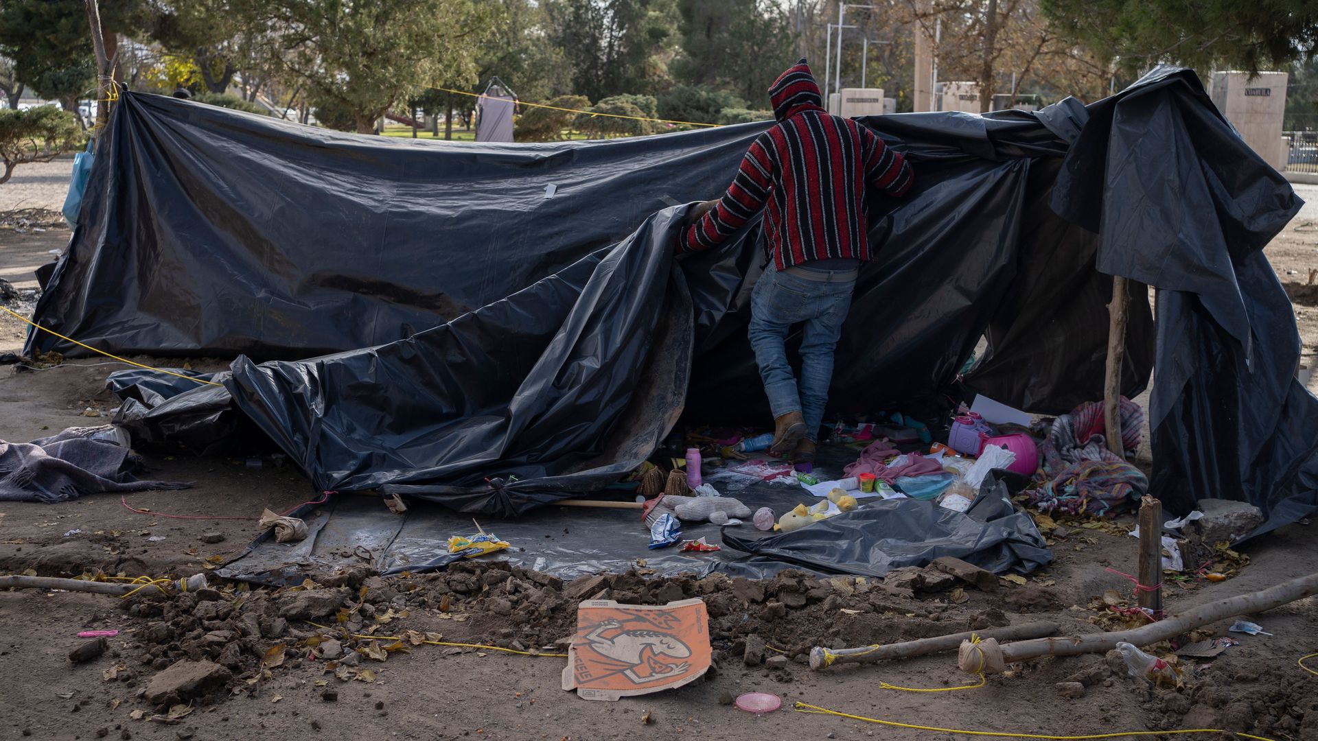 man breaks down campsite as he waits to file for asylum