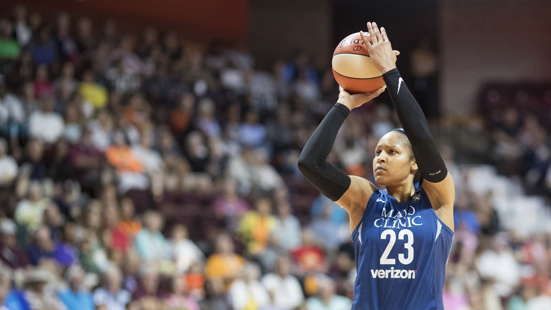 lady shooting a basketball