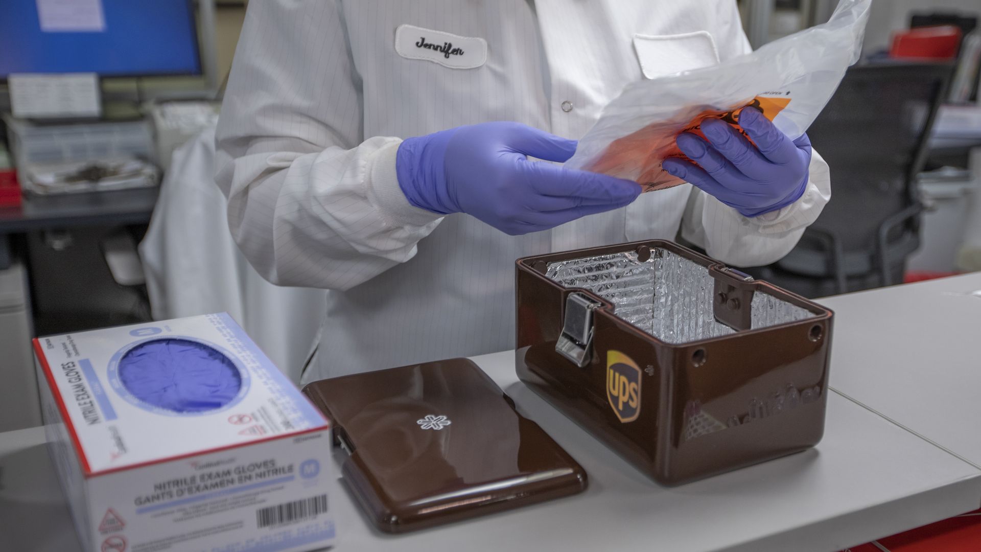 a medical professional opening a UPS dron epackage
