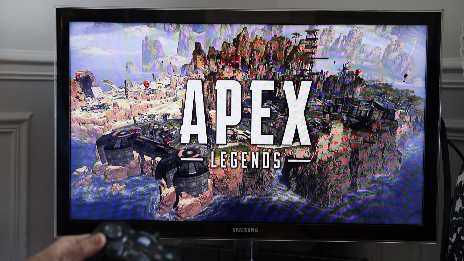 A tv with Apex Legends video game on it.