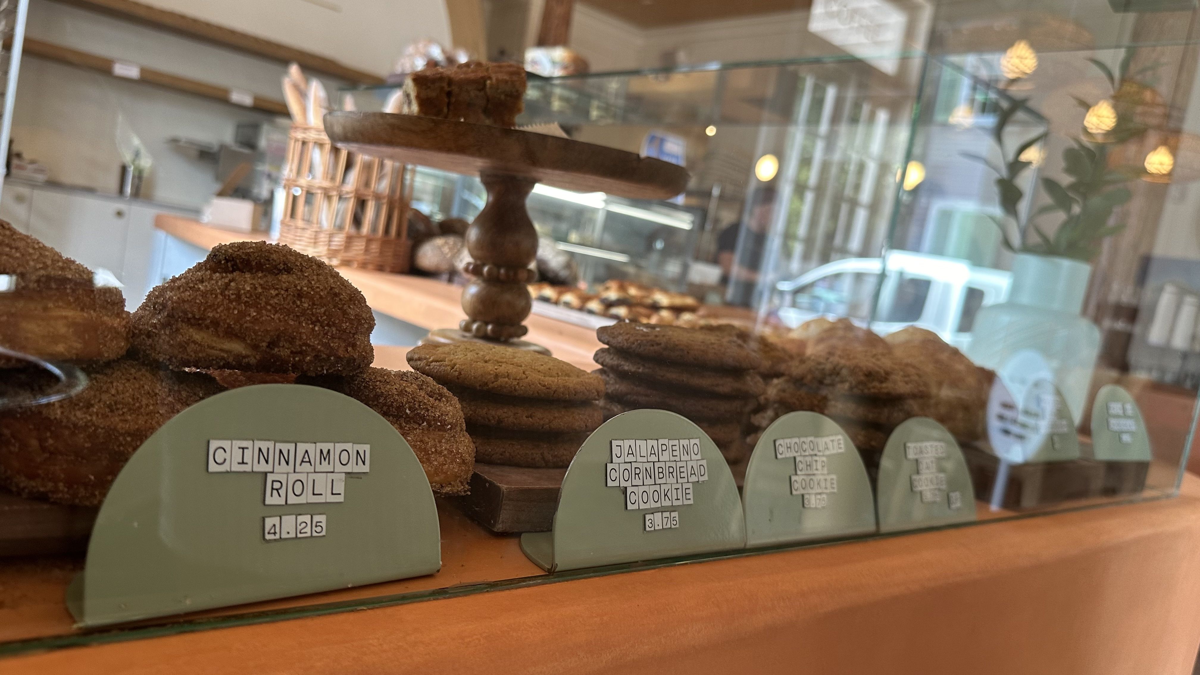 A close-up photo of a display case of baked goods, including cinnamon rolls and cookies.