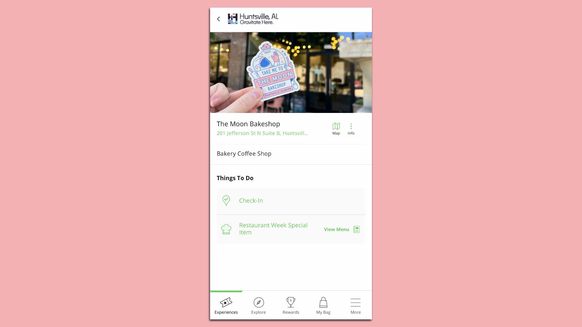 A mobile app screen showing The Moon Bakeshop info in Huntsville, AL. A hand holds a colorful sticker reading "Take me to THE MOON BAKESHOP" with a cupcake, moon, and space theme.