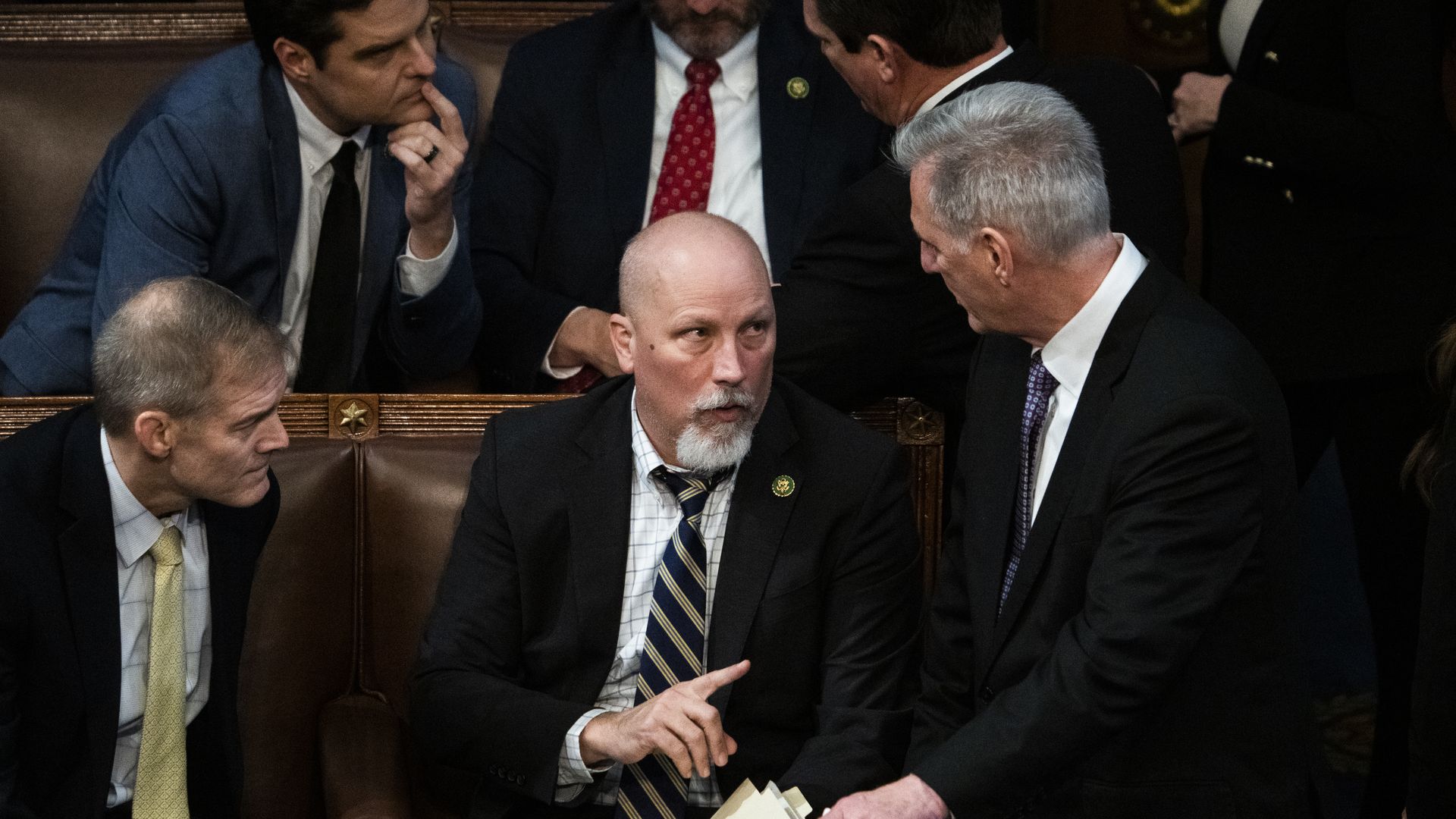 Chip Roy consults with Kevin McCarthy on the U.S. House floor.