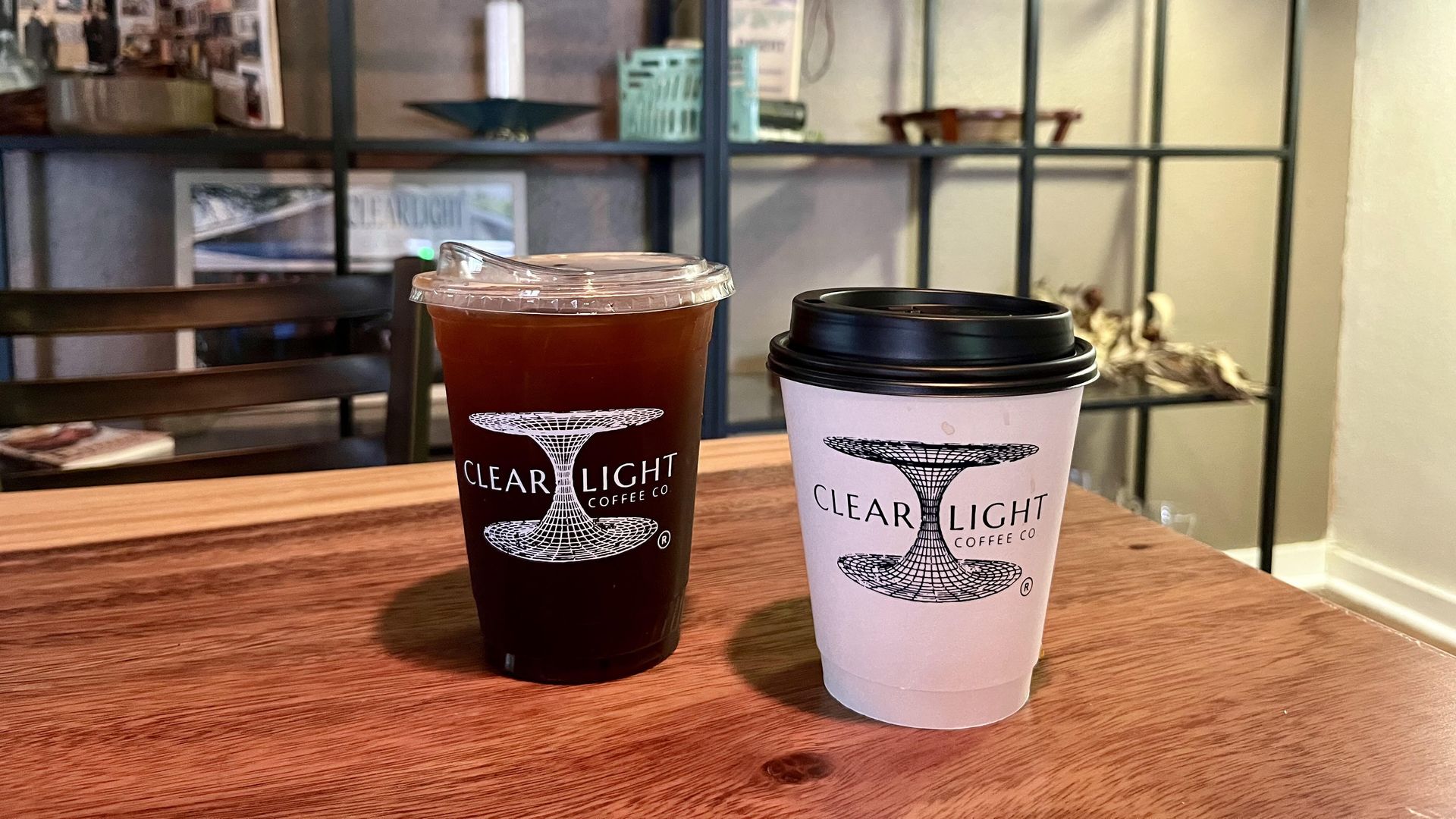 Two cups of coffee on a wooden table.