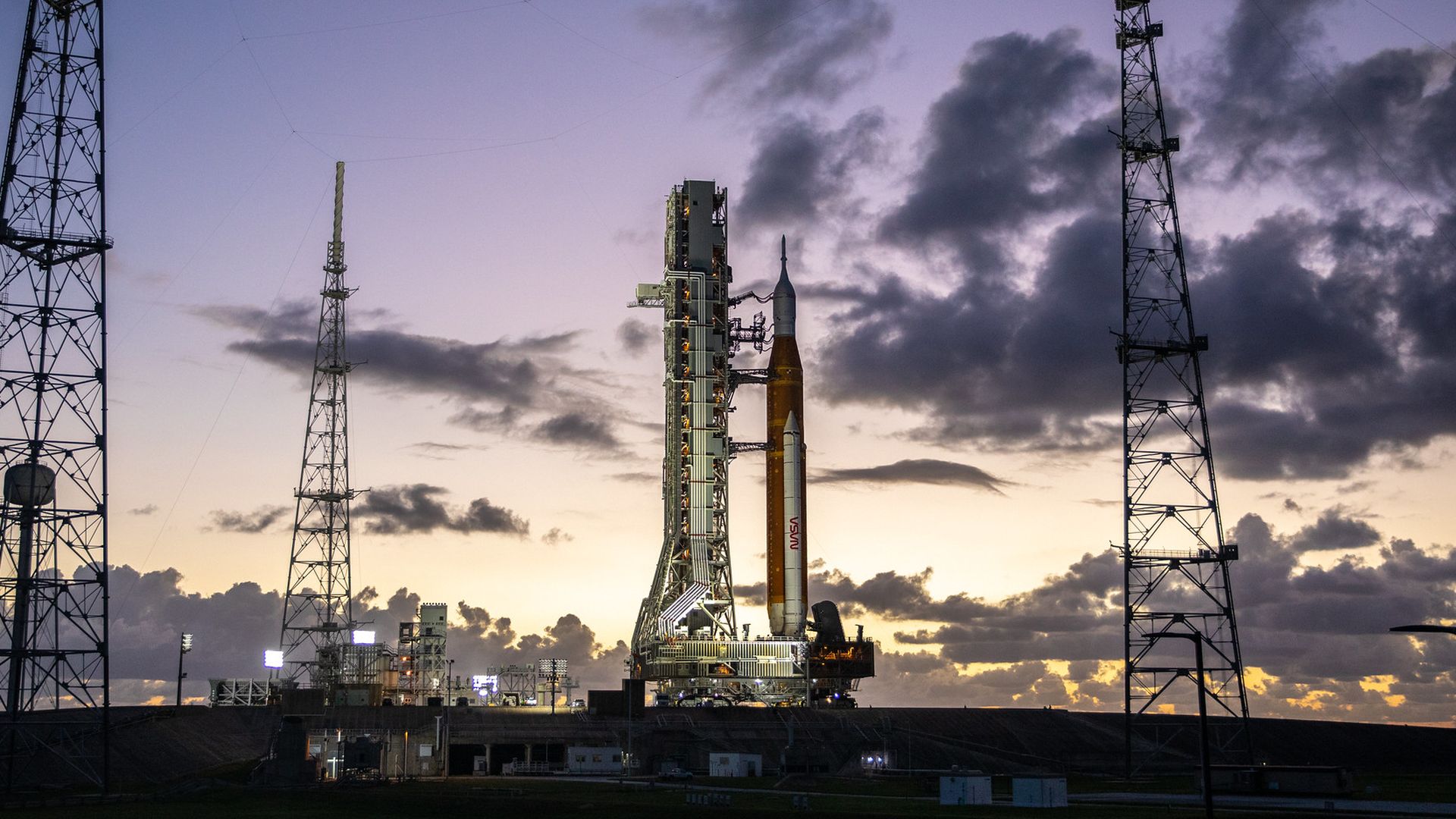 The SLS rocket awaiting launch against a purple sky
