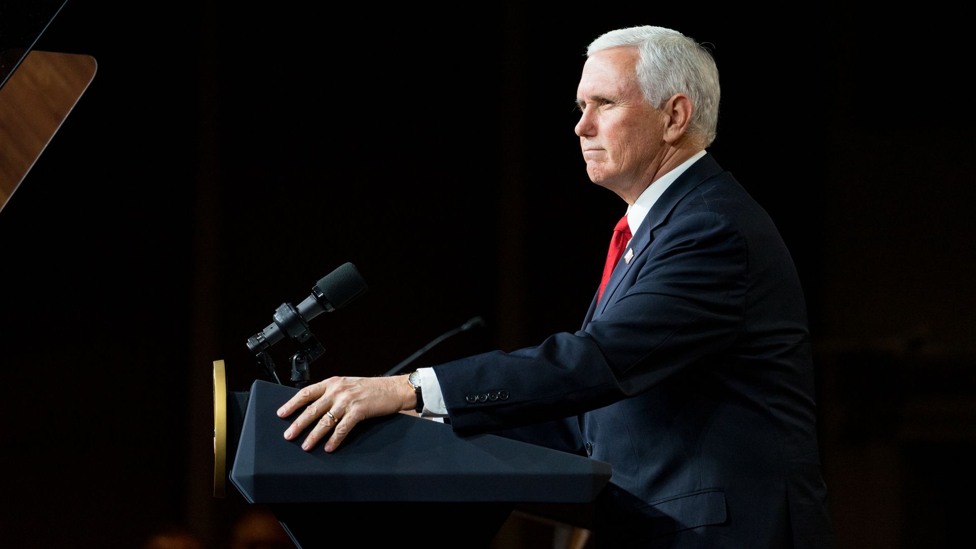 Pence stands at a podium