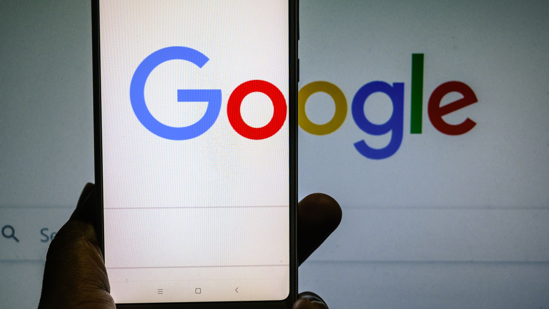 The Google logo appears on both a phone screen and a computer monitor.