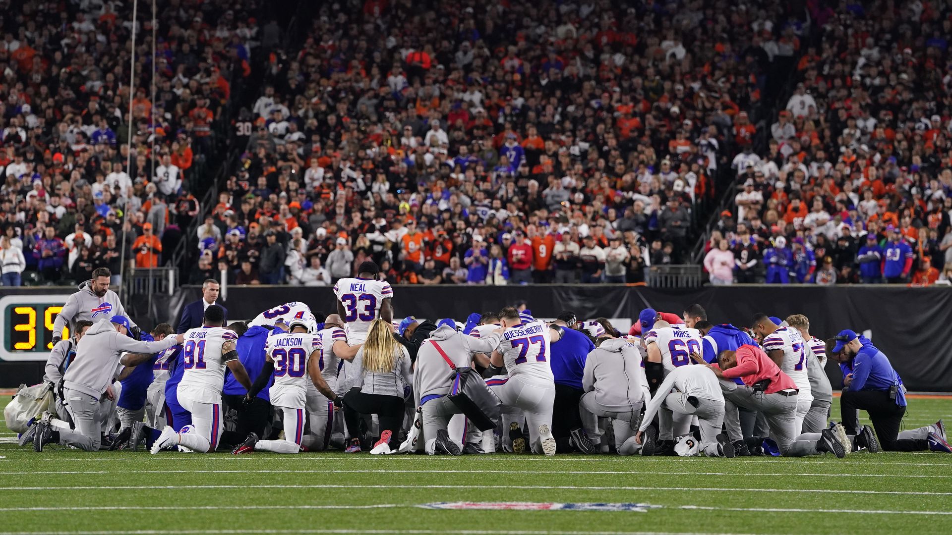 Buffalo Bills players huddle and pray after teammate Damar Hamlin #3 collapsed on the field after making a tackle against the Cincinnati Bengals in Cincinnati, Ohio, Jan. 3. 