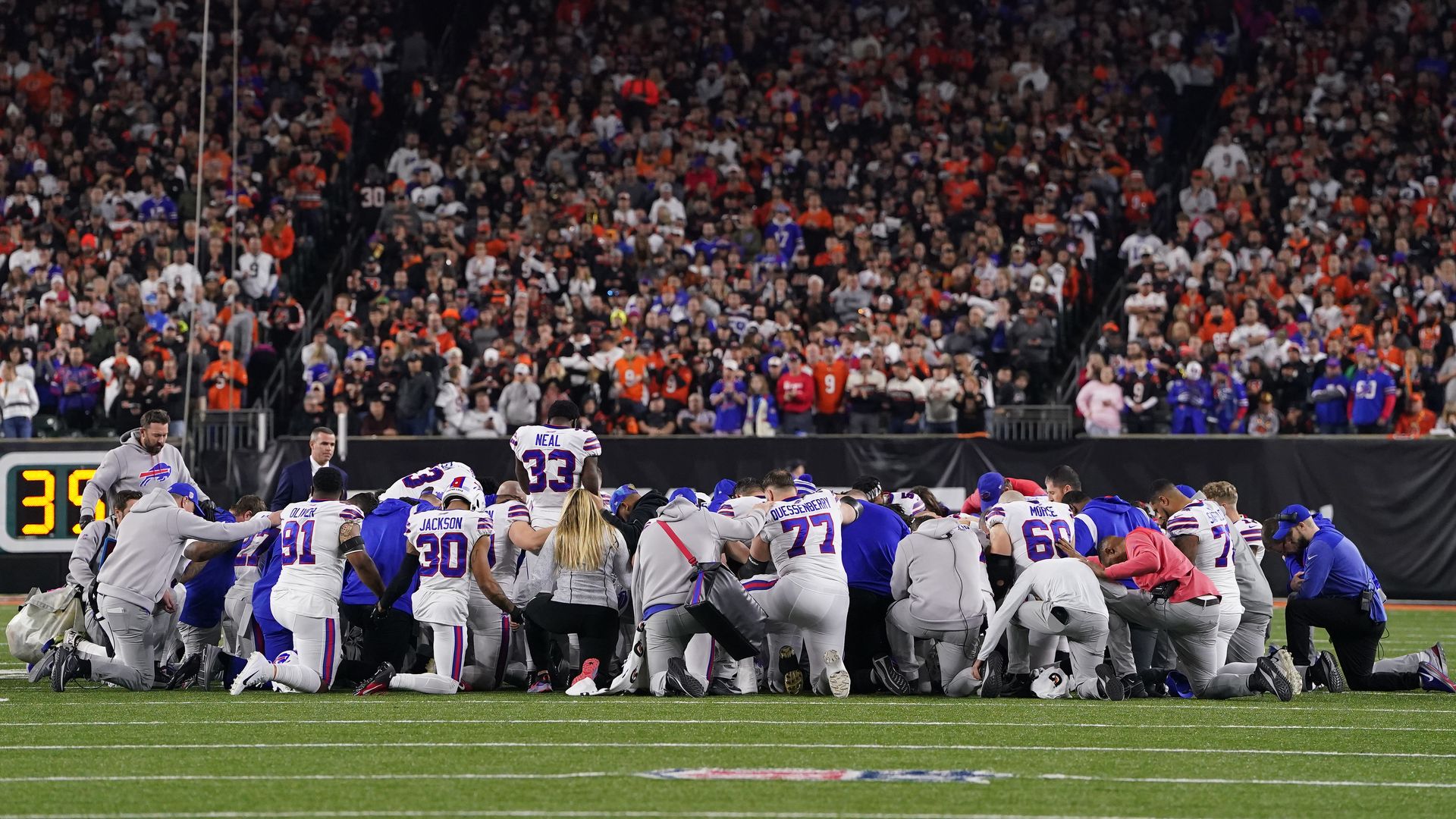 Buffalo Bills players huddle and pray after teammate Damar Hamlin #3 collapsed on the field after making a tackle against the Cincinnati Bengals in Cincinnati, Ohio, Jan. 3.