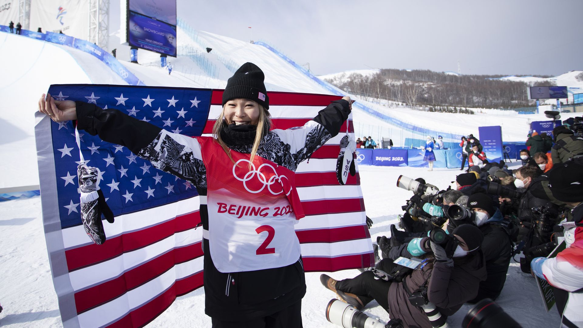 Chloe Kim of the US reacts with the United States flag after winning gold in the Women's Snowboard Halfpipe Final at the Winter Olympic Games on February 10th, 2022 in Zhangjiakou, China. (