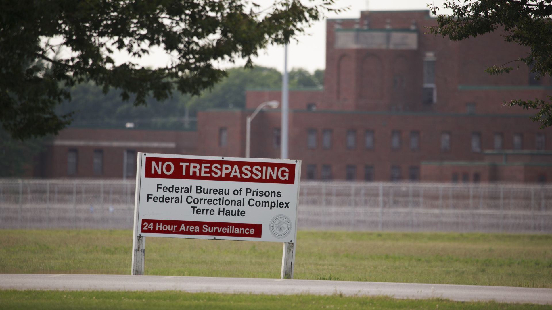 Picture of a sign in front of the Terre Haute Federal Correctional Complex indicating that the area is under surveillance.