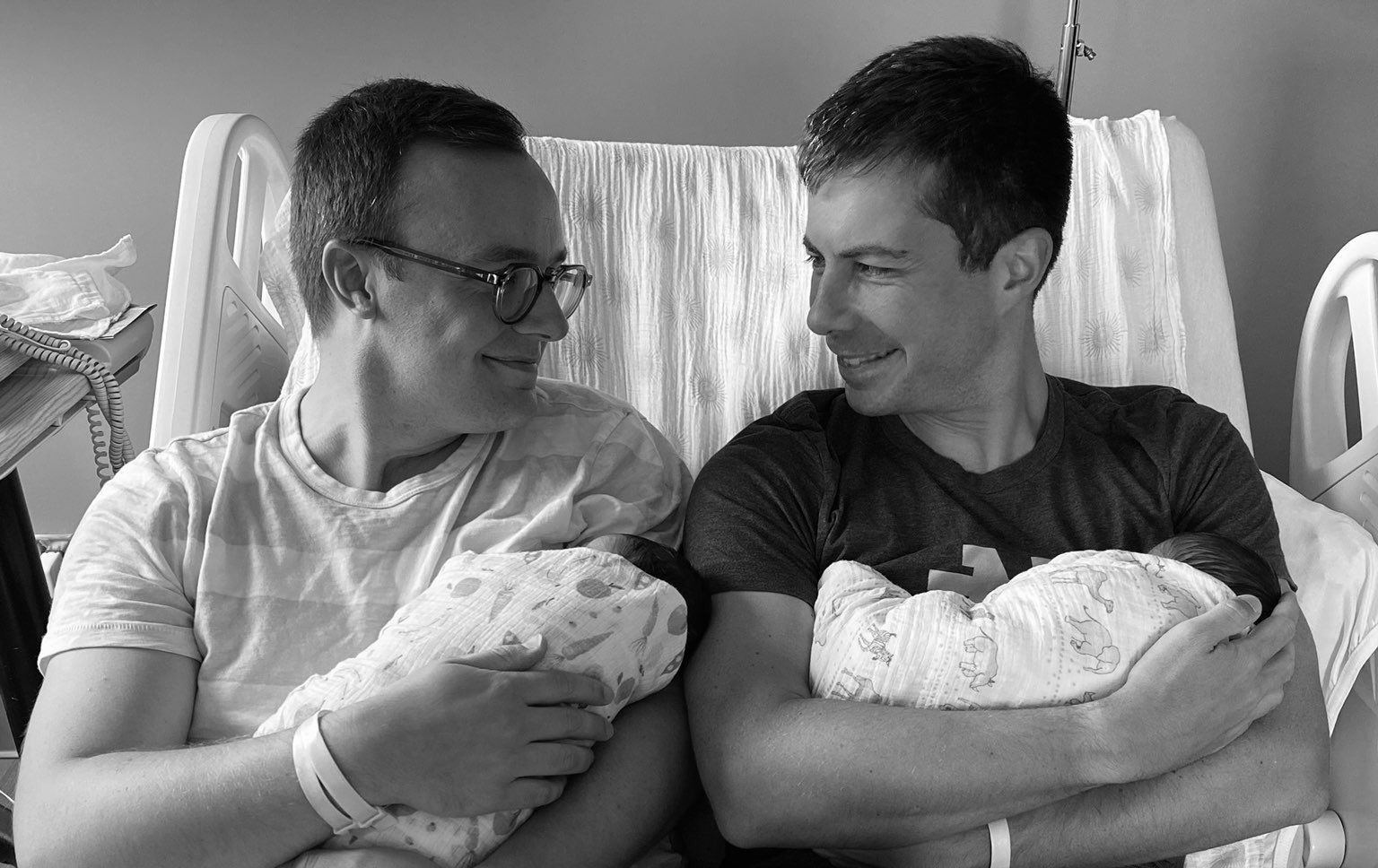 Image of Pete Buttigieg and his husband Chasten holding their new babies.