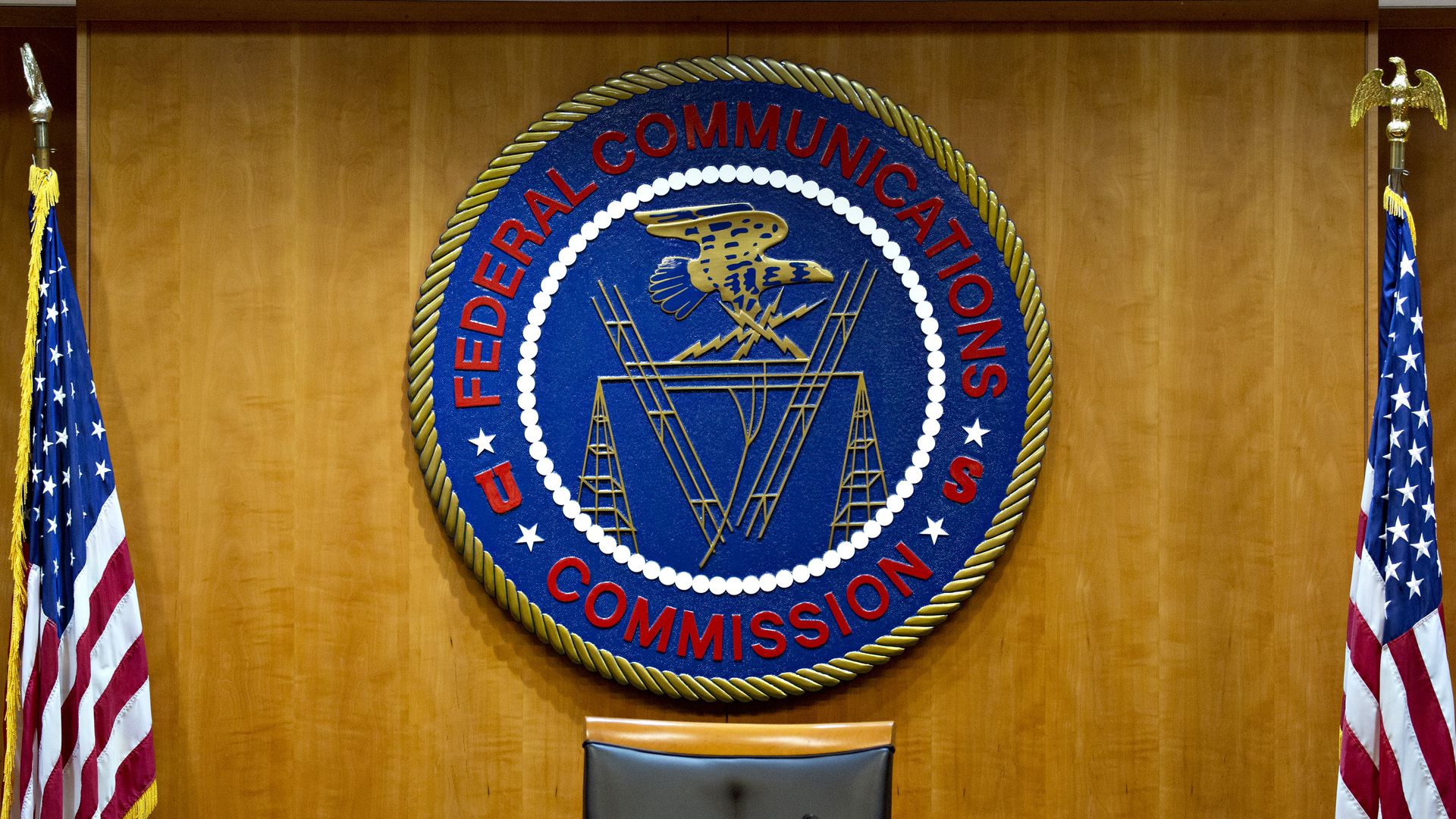 Photo of a large blue and red seal that says "Federal Communications Commission"