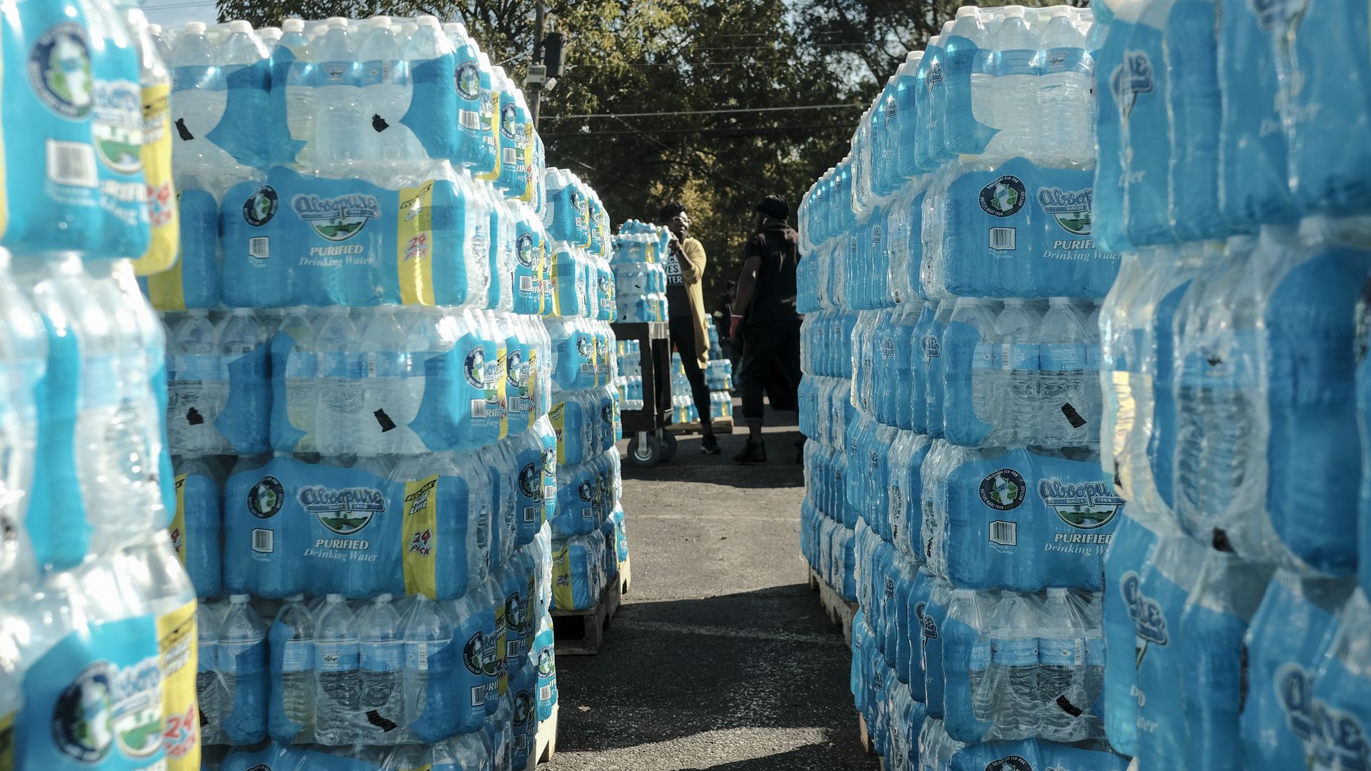 Volunteers distribute bottled water to residents