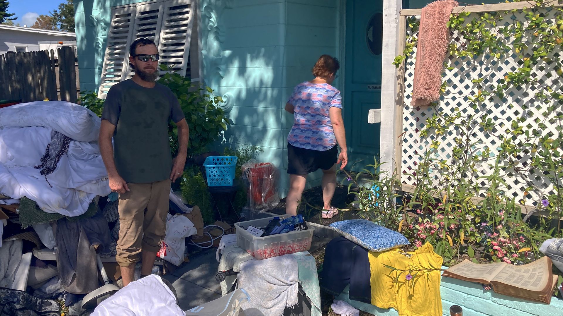 Derreck Prosser and Vicky Goude clean up their home after Hurricane Helene passed offshore, on Sept. 29, in St. Pete.