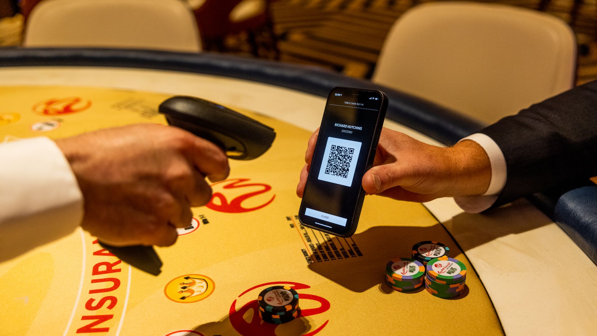 Someone scans a QR code on a digital wallet app on a smartphone