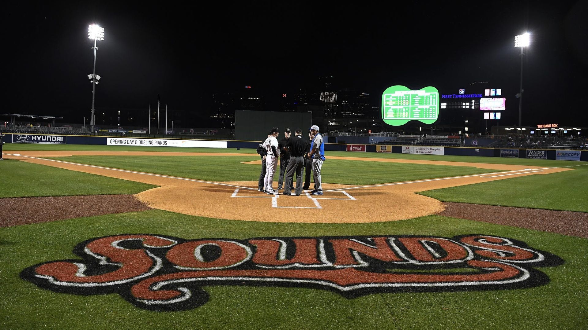 Team members gathered on a baseball diamond
