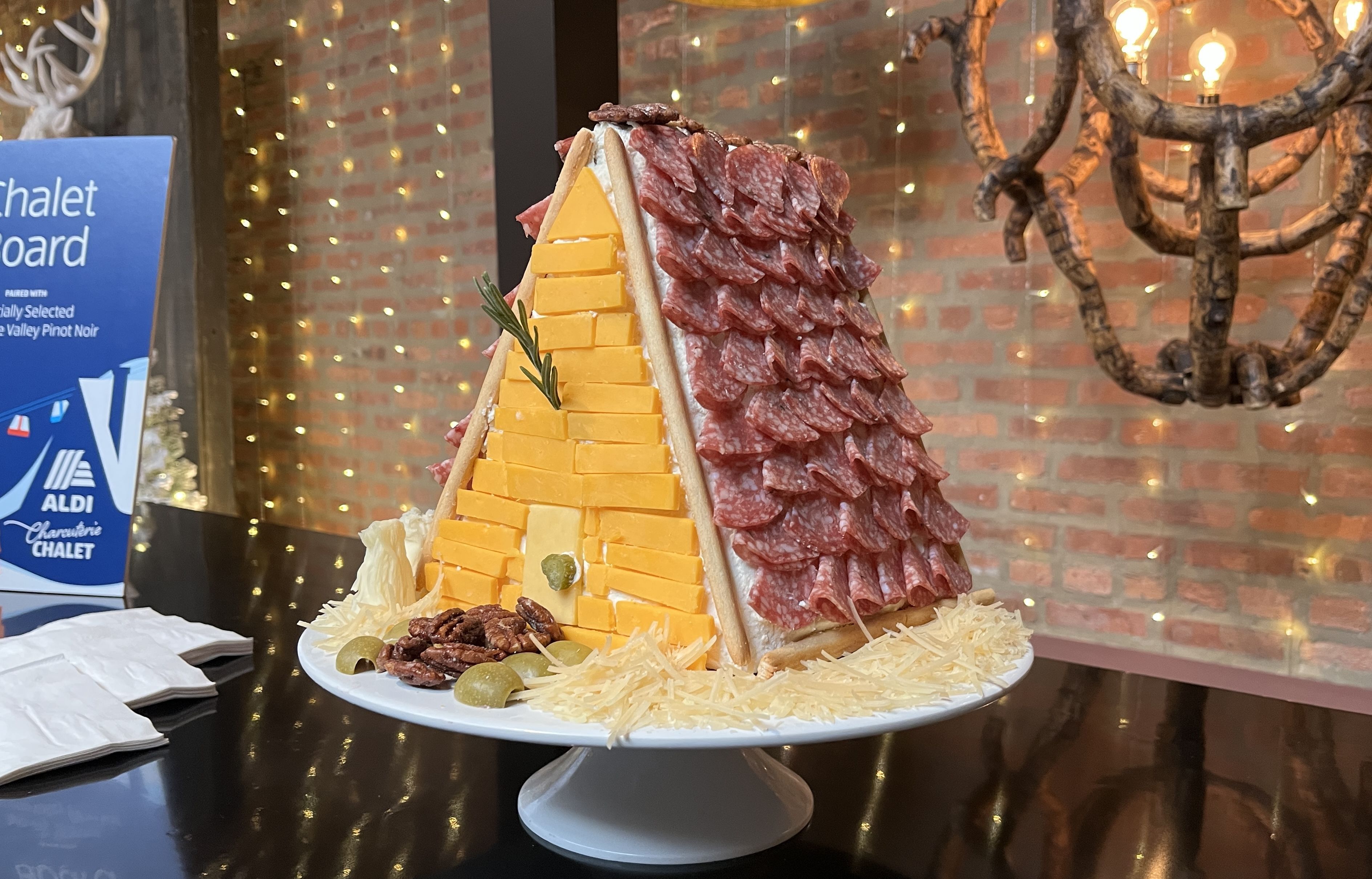 A chalet made from cheese, pickles, breadsticks and salami at the Aldi charcuterie chalet. 