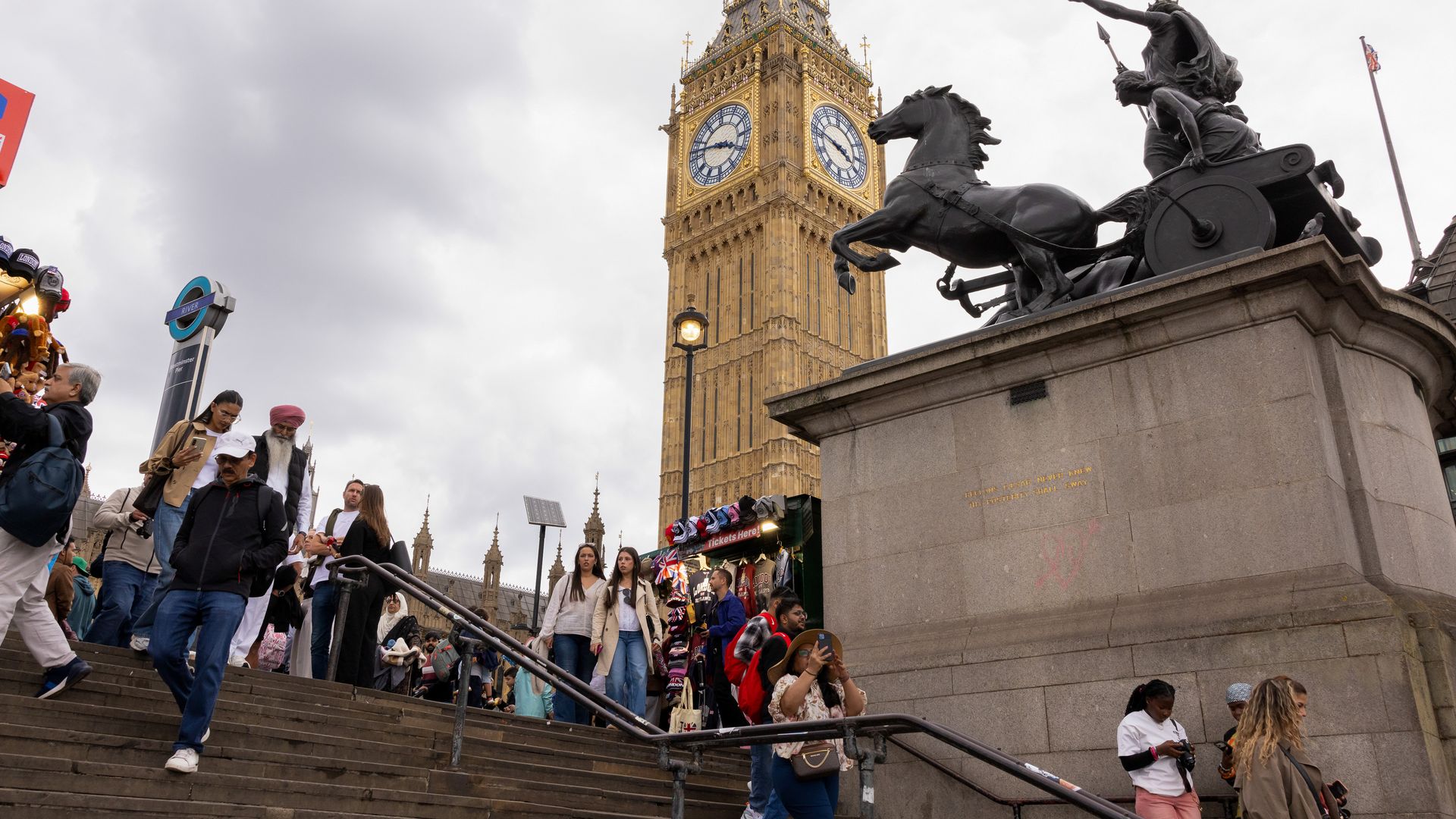 tourists walk by Big Ben.