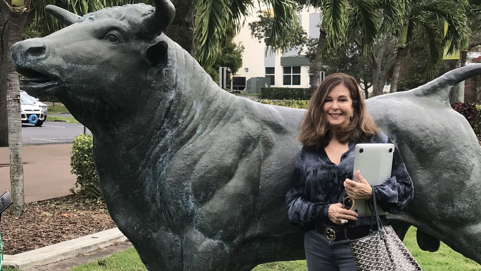 Kathleen in front of a statue of a bull at USF