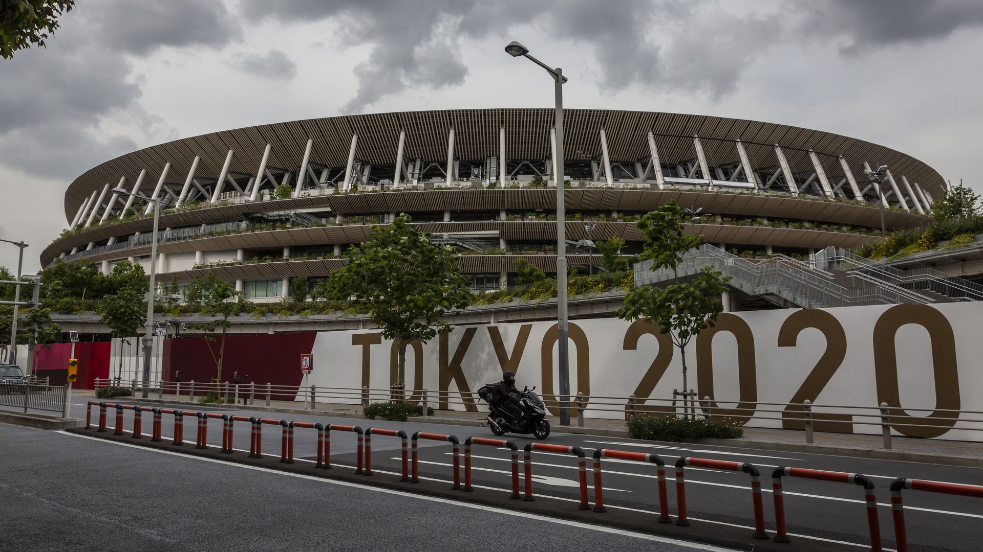 A sign that says "Tokyo 2020" outside a colosseum 