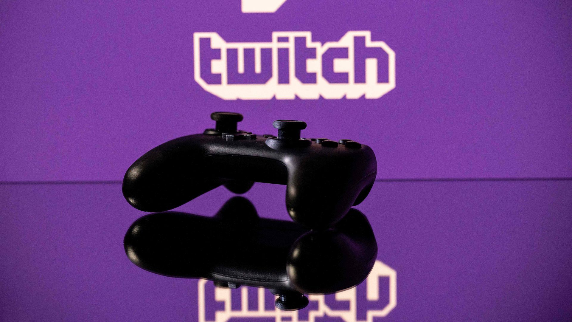 A video game controller with a twitch logo behind it