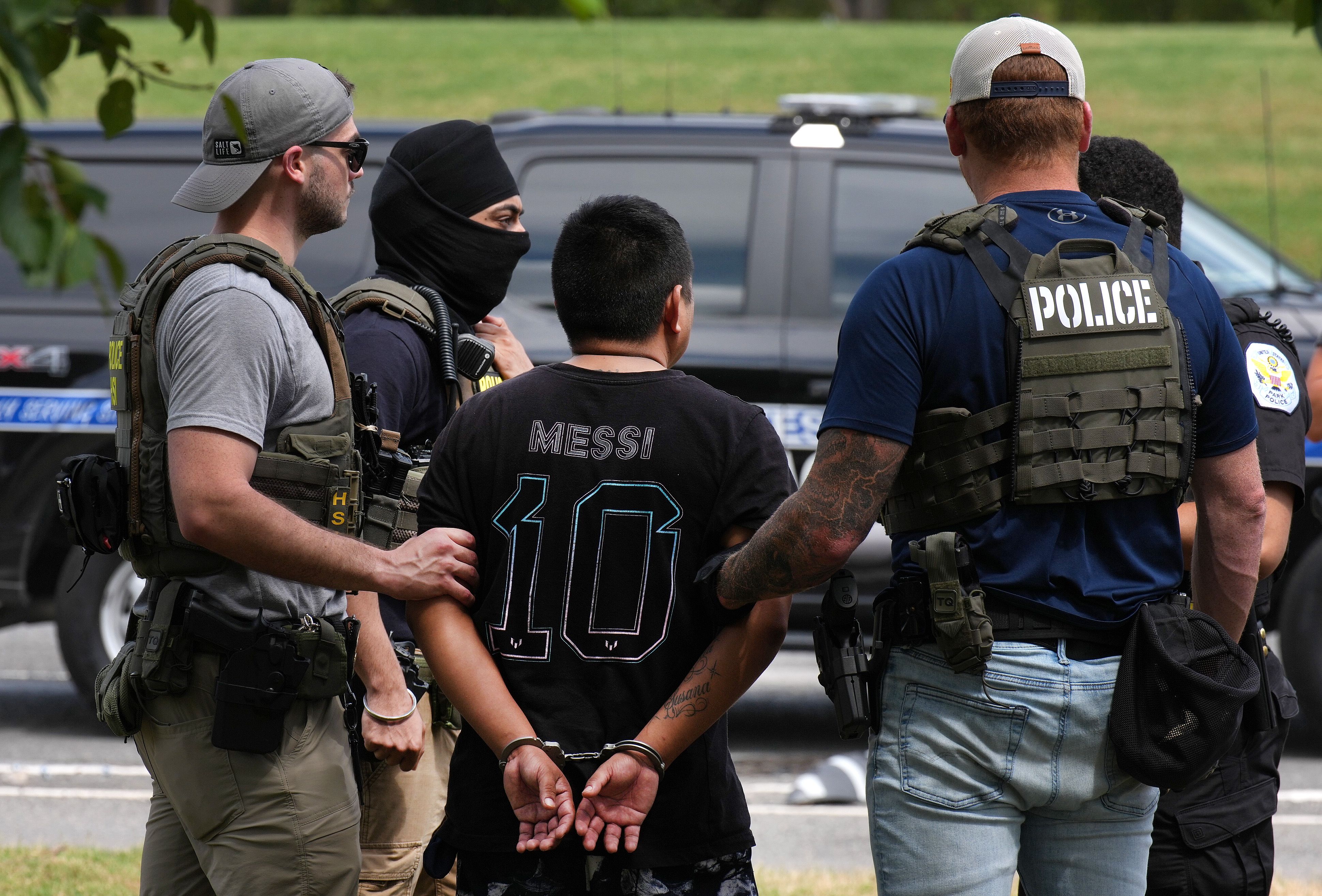 Law enforcement officers detain a man