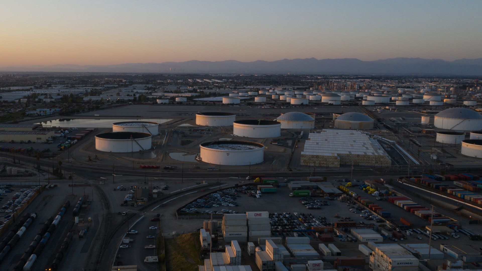An eagle's eye view of tall, white oil storage tanks 
