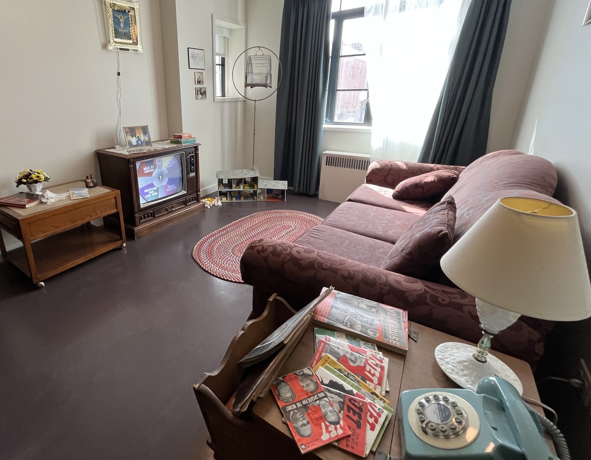 A living room with a couch and TV and old copies of "Jet" magazine.