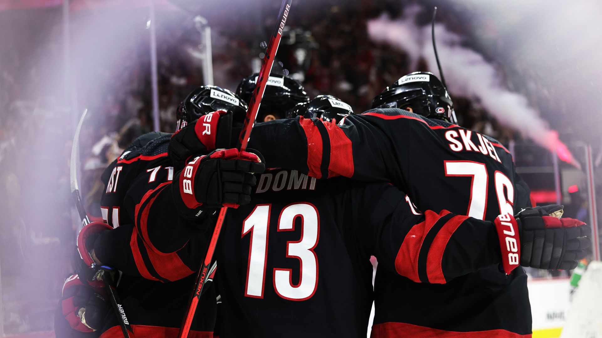 Canes players celebrating after their Game 7 win in the first round of the playoffs