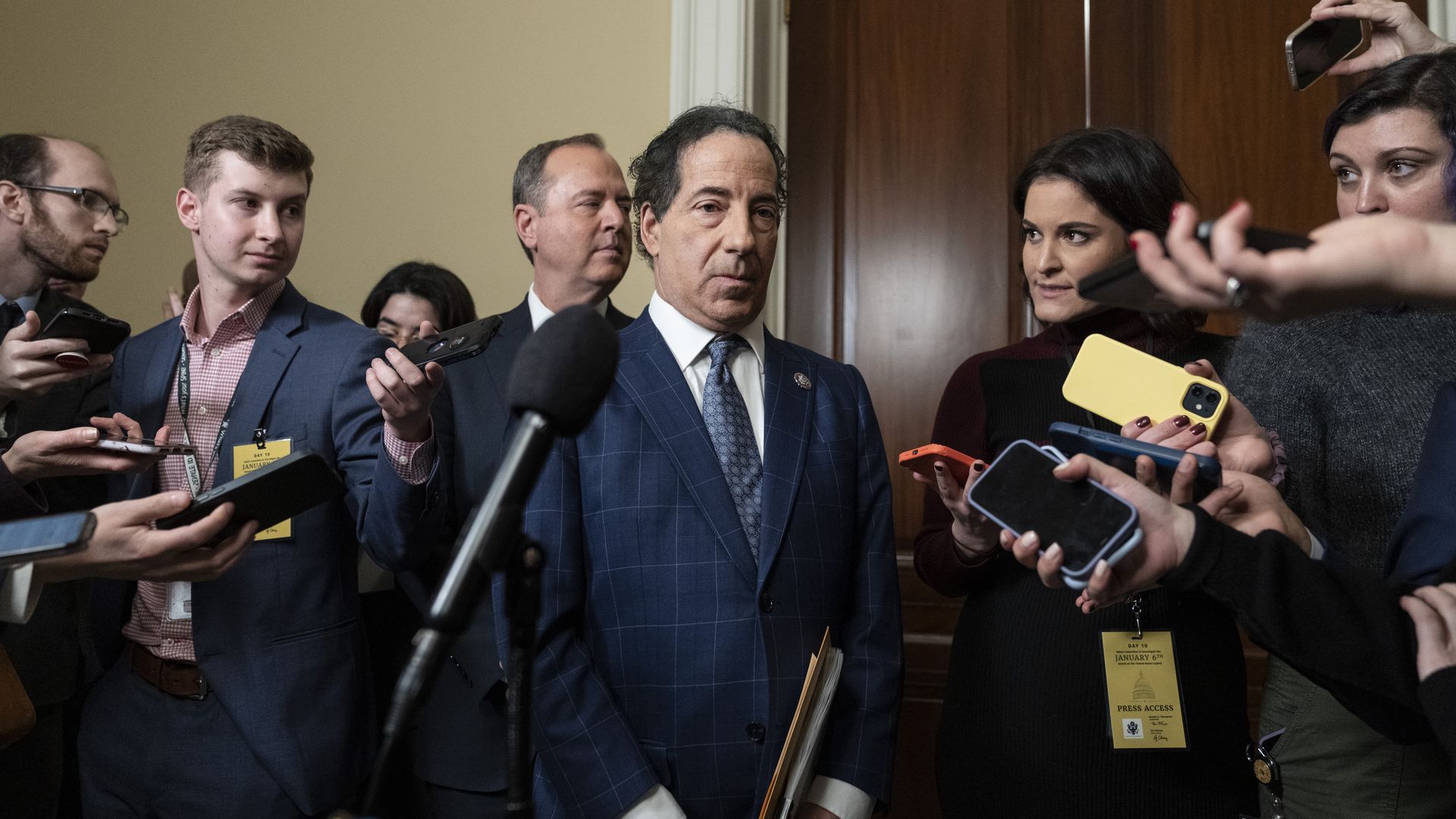Rep. Jamie Raskin, wearing a blue suit, white shirt and blue tie, speaks to reporters after a Jan. 6 hearing.