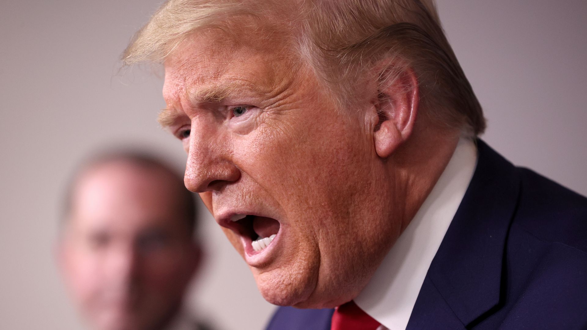 In this image, Trump talks