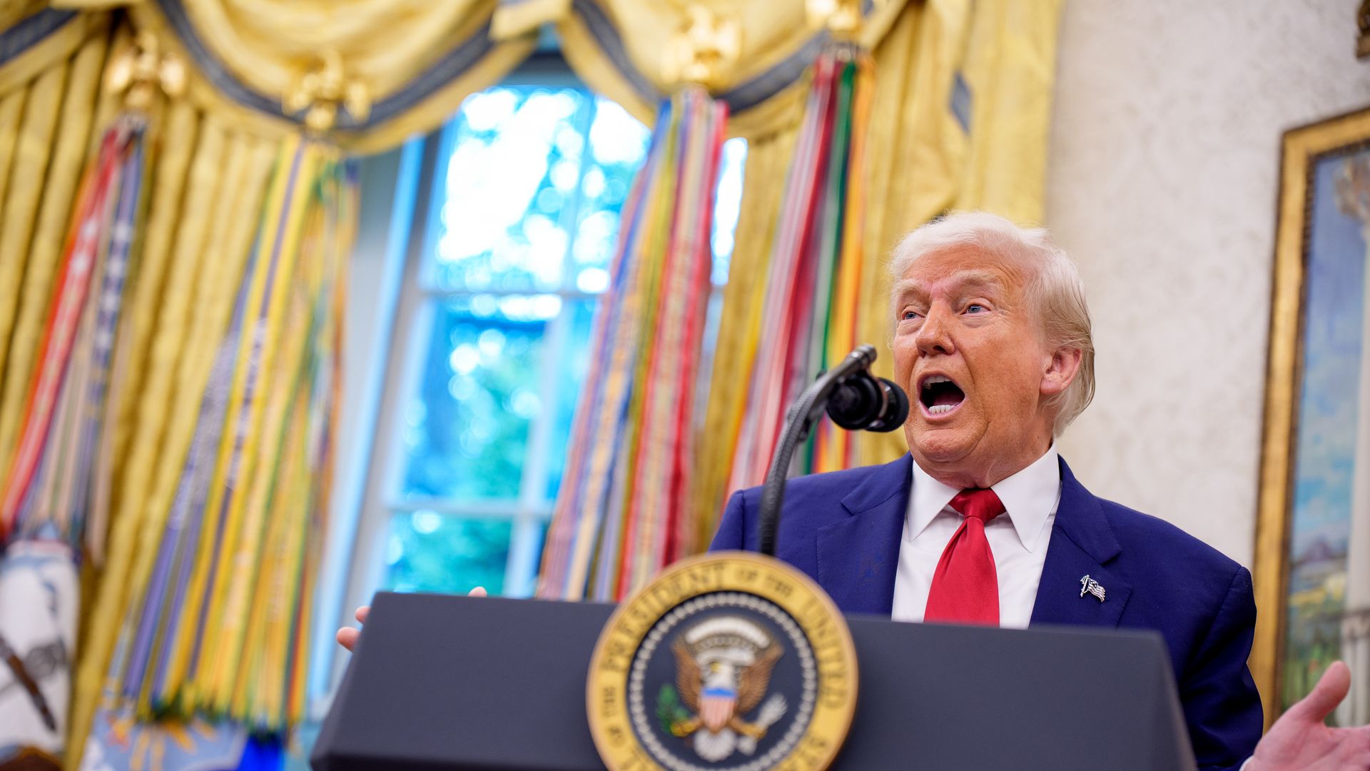 President Trump at a lectern in the Oval Office.