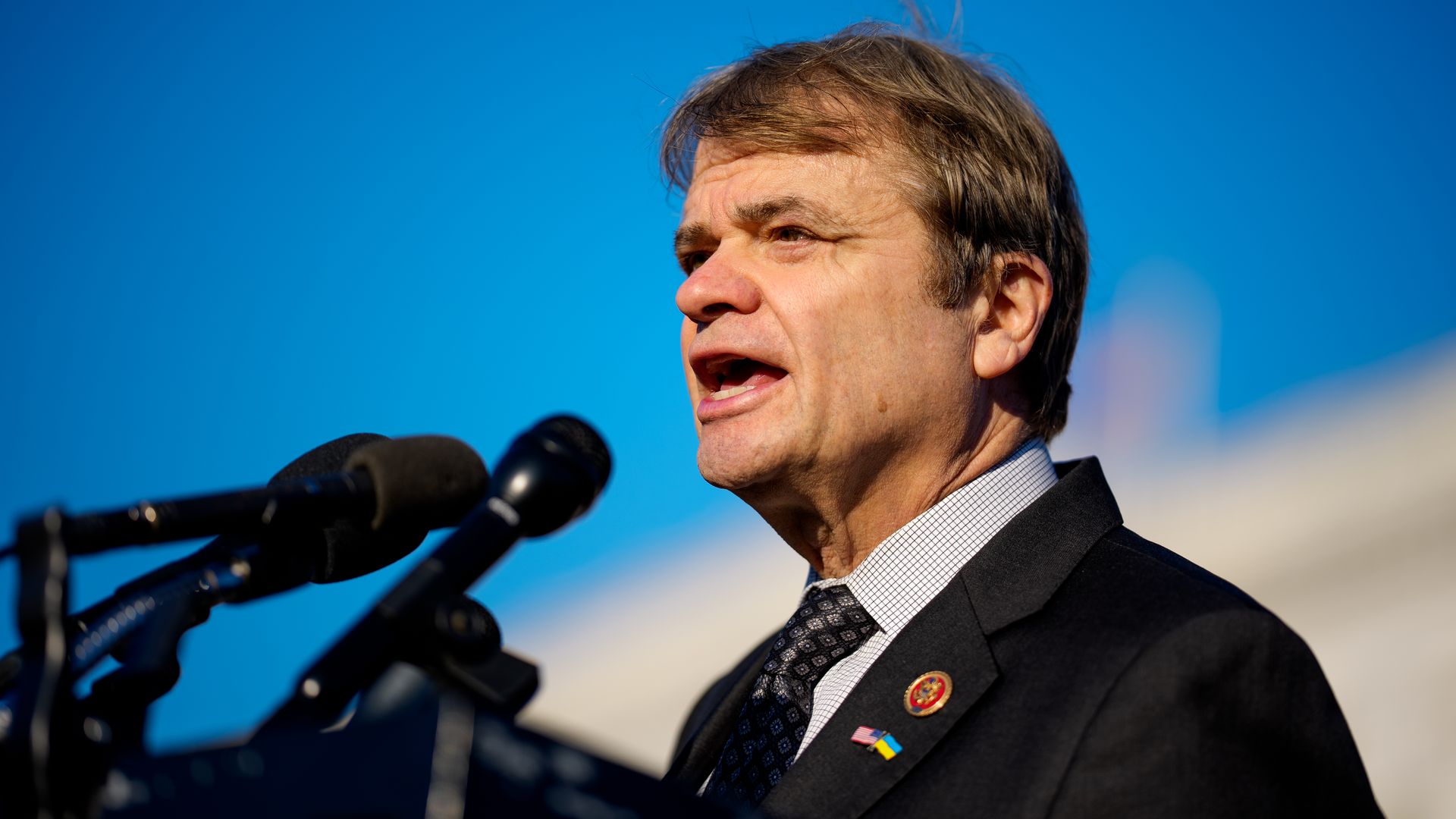 Man in suit at microphone 