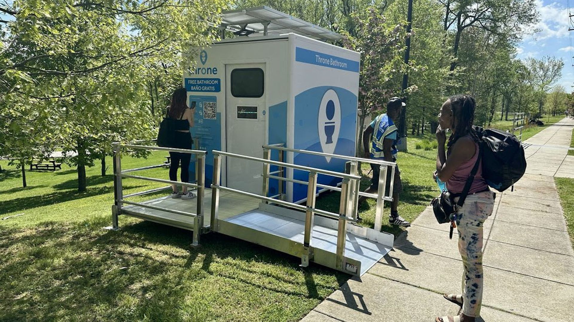 A Throne bathroom in D.C. with people around it 
