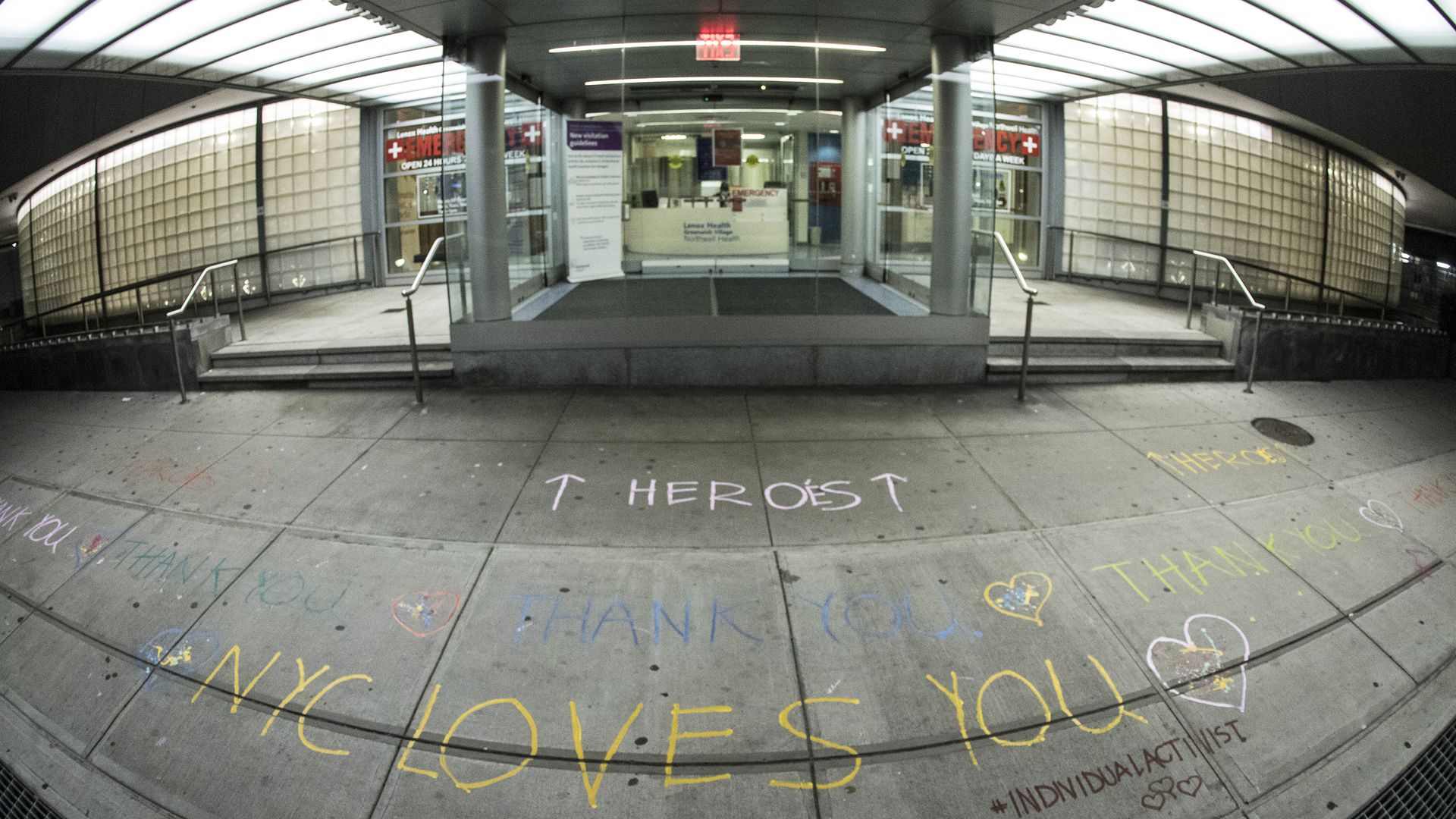 A photo of thank-you messages drawn in chalk in front of a New York City emergency room.