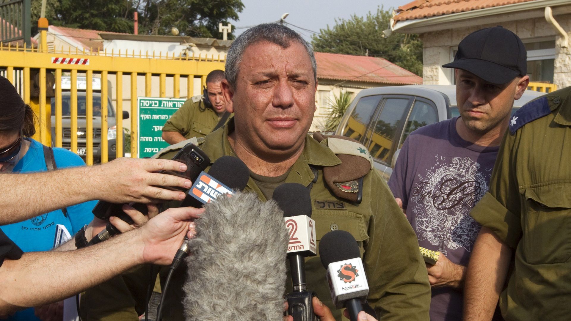 Israeli Defense chief talks while surrounded by reporters
