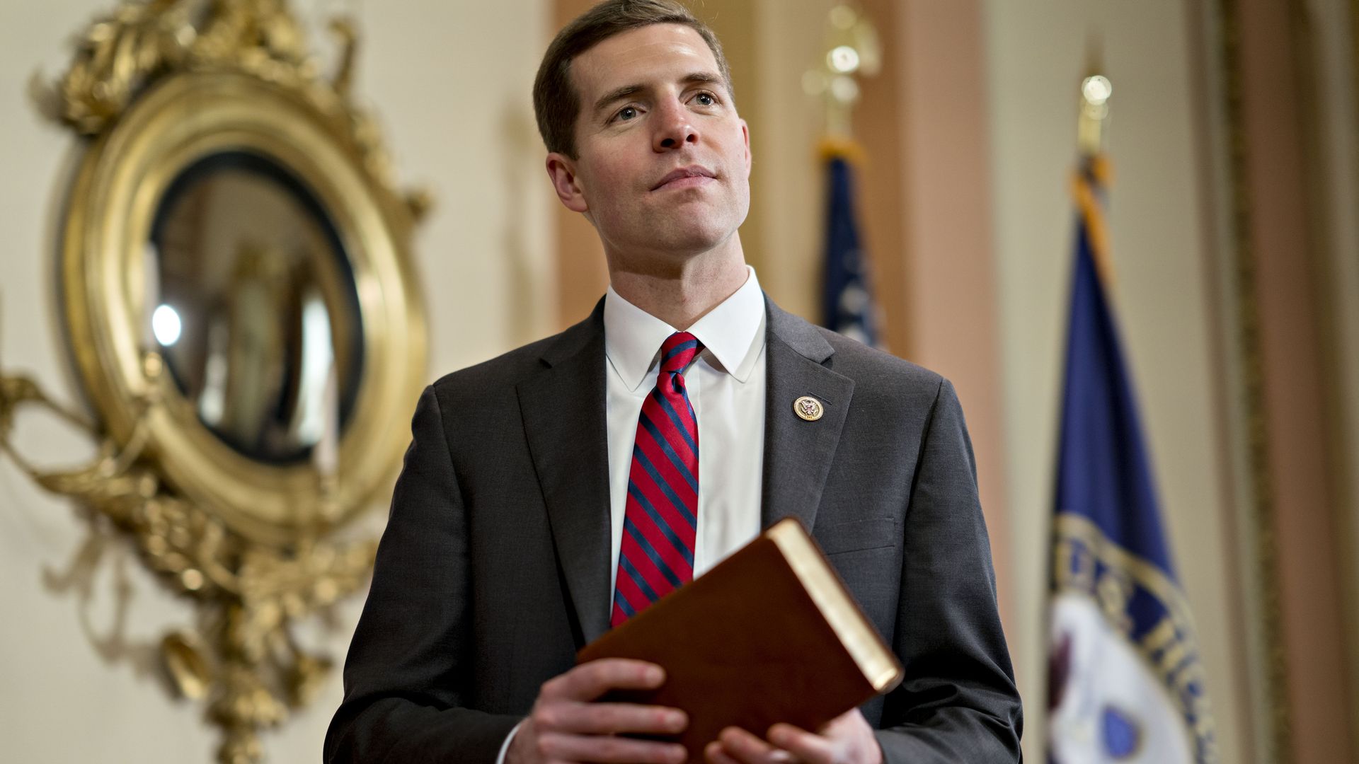 Rep. Conor Lamb holding a book