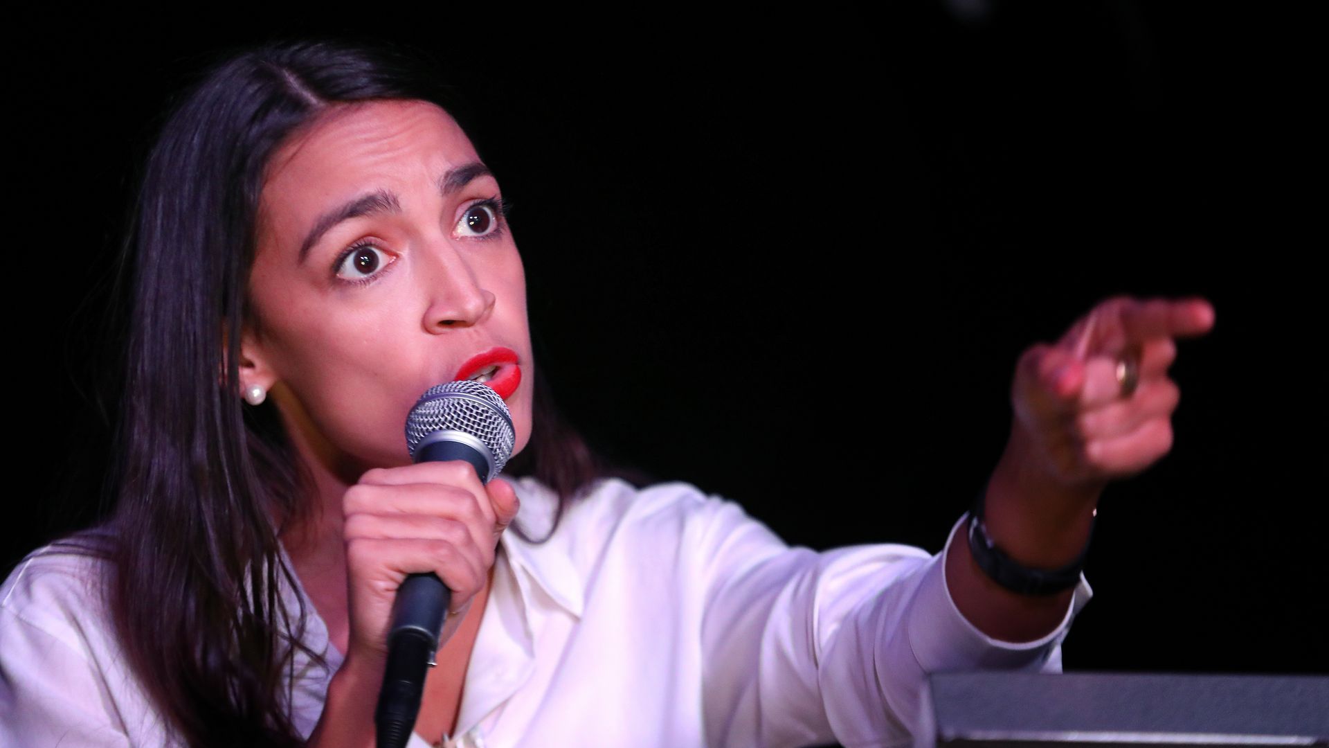 Alexandria Ocasio-Cortez points finger.