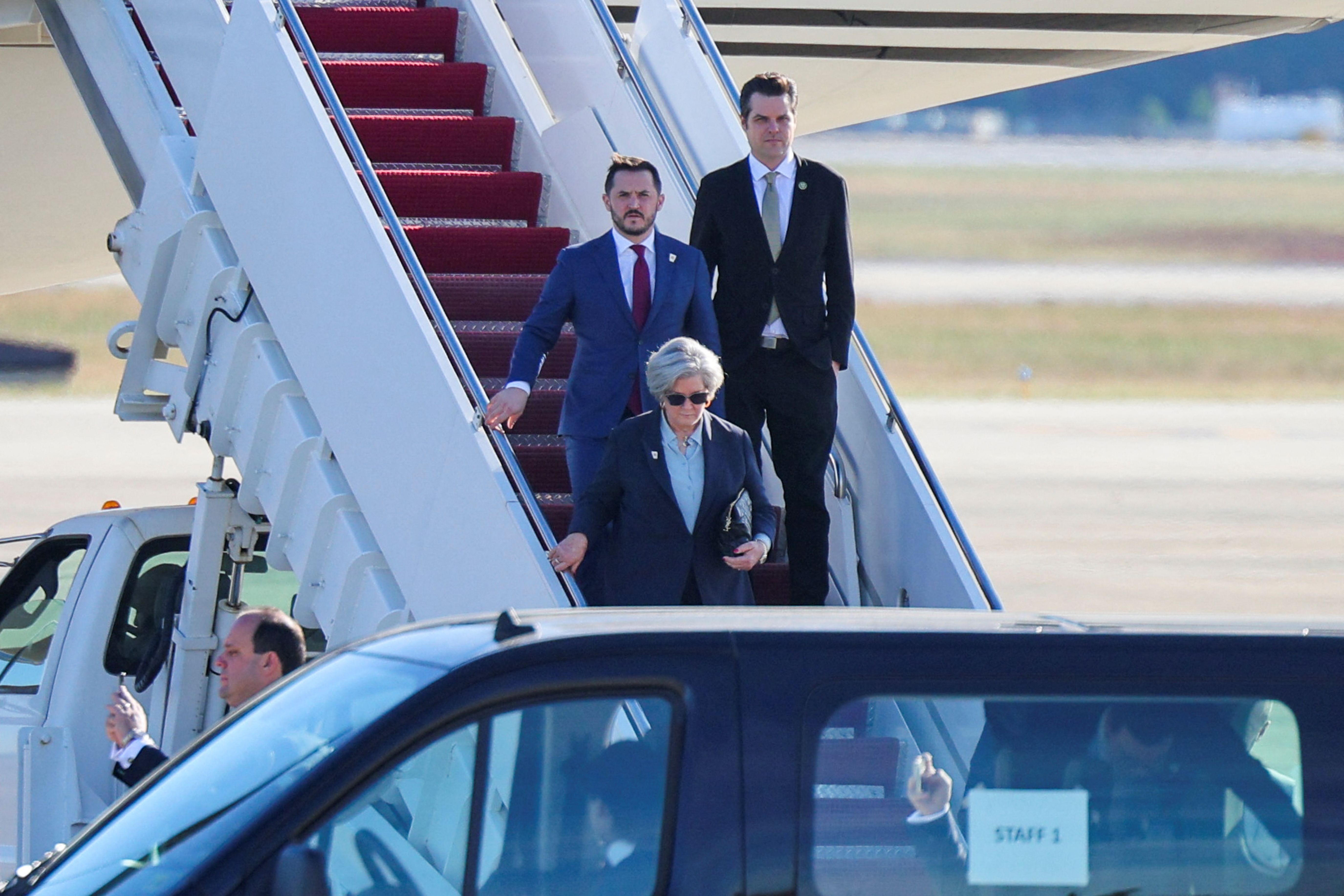Rep. Matt Gaetz (right) and incoming White House Chief of Staff Susie Wiles arrive at Joint Base Andrews on President-elect Trump's plane yesterday. Photo: Brian Snyder/Reuters