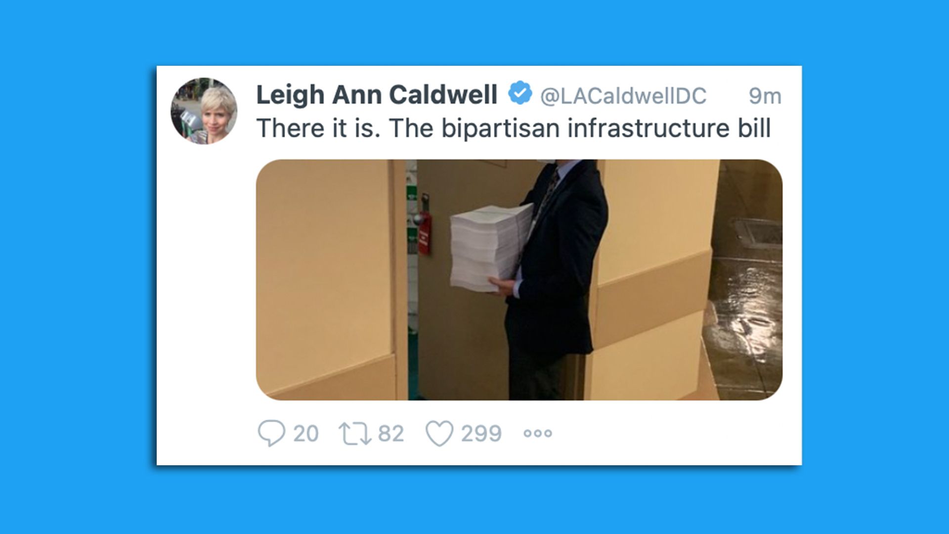 A screenshot shows a Senate aide holding a freshly printed copy of the bipartisan infrastructure bill.