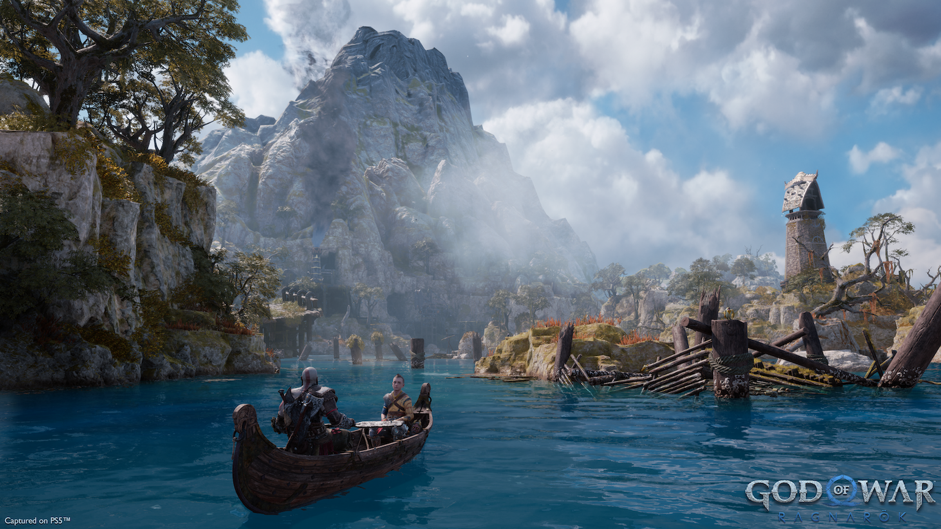 Video game screenshot of a man and a boy in a canoe with a mountain in the distance