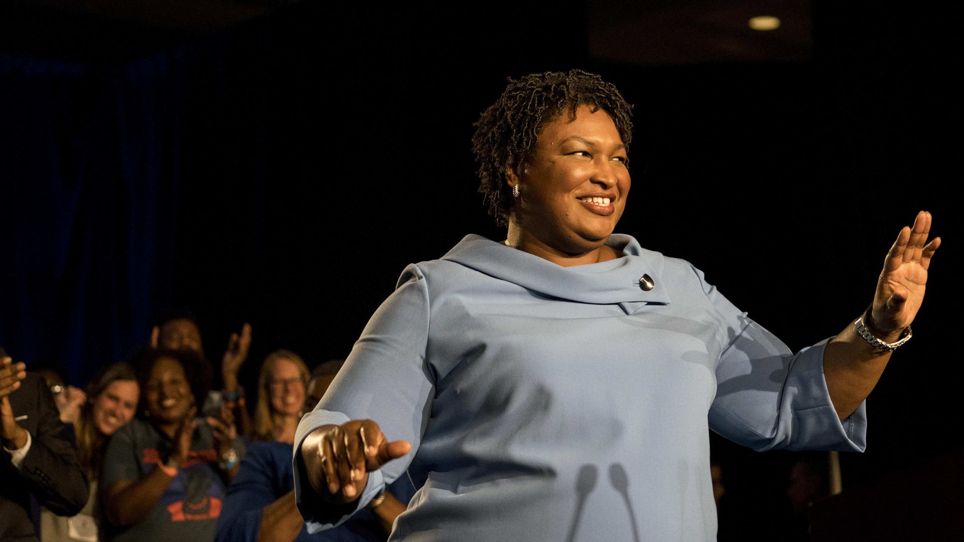 Stacey Abrams waving on stage