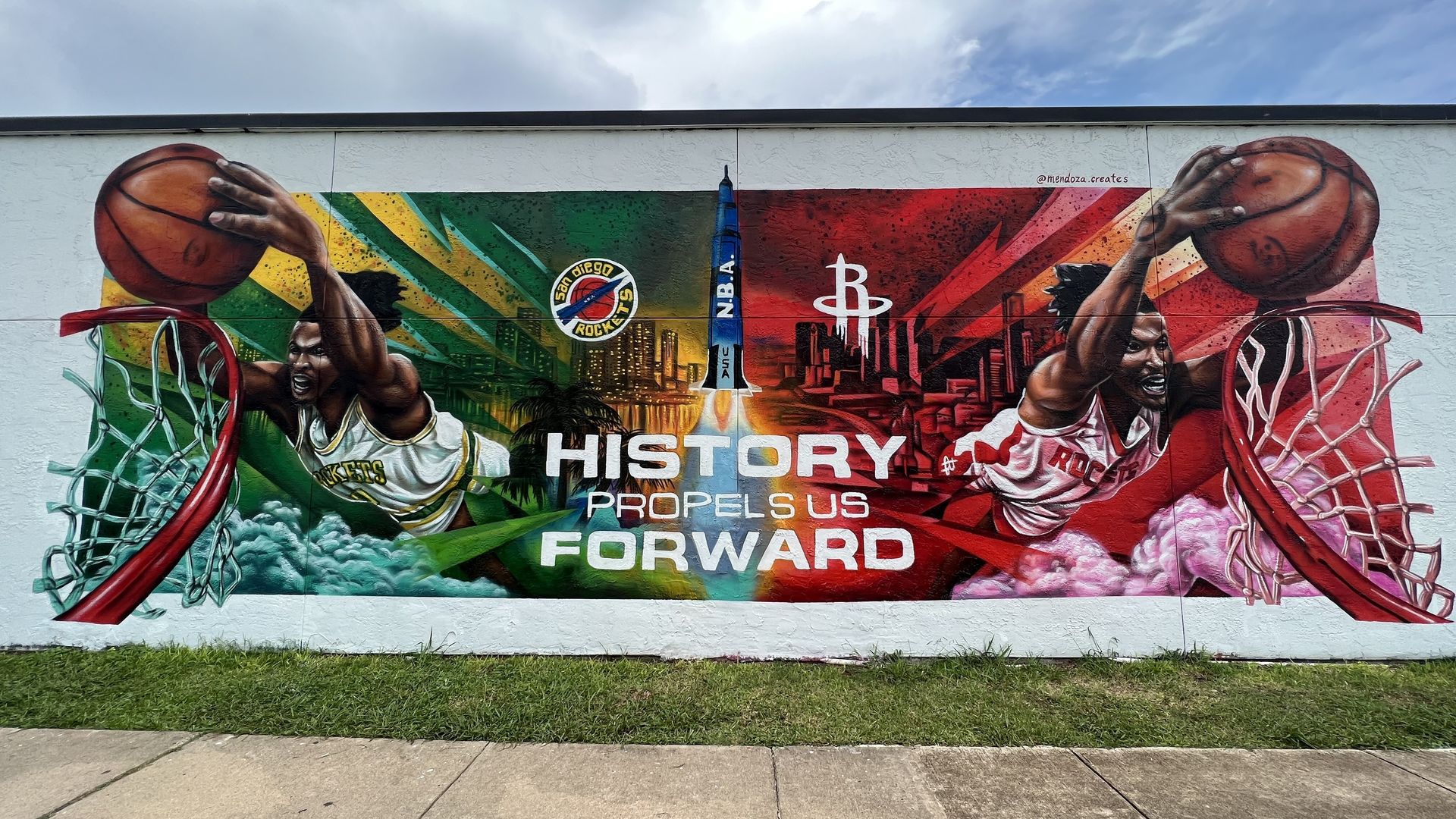 A green, gold and red mural dedicating the Houston Rockets' new jerseys painted on the side of a vacant building