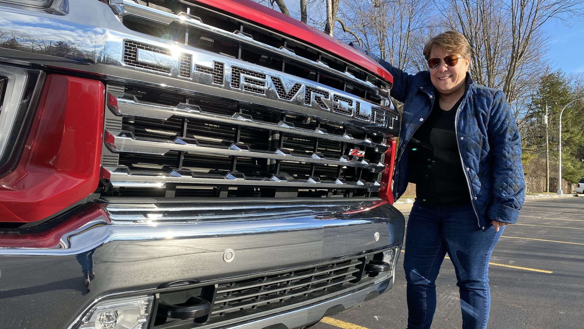 Writer Joann Muller standing next to the vehicle, which is taller than her. 