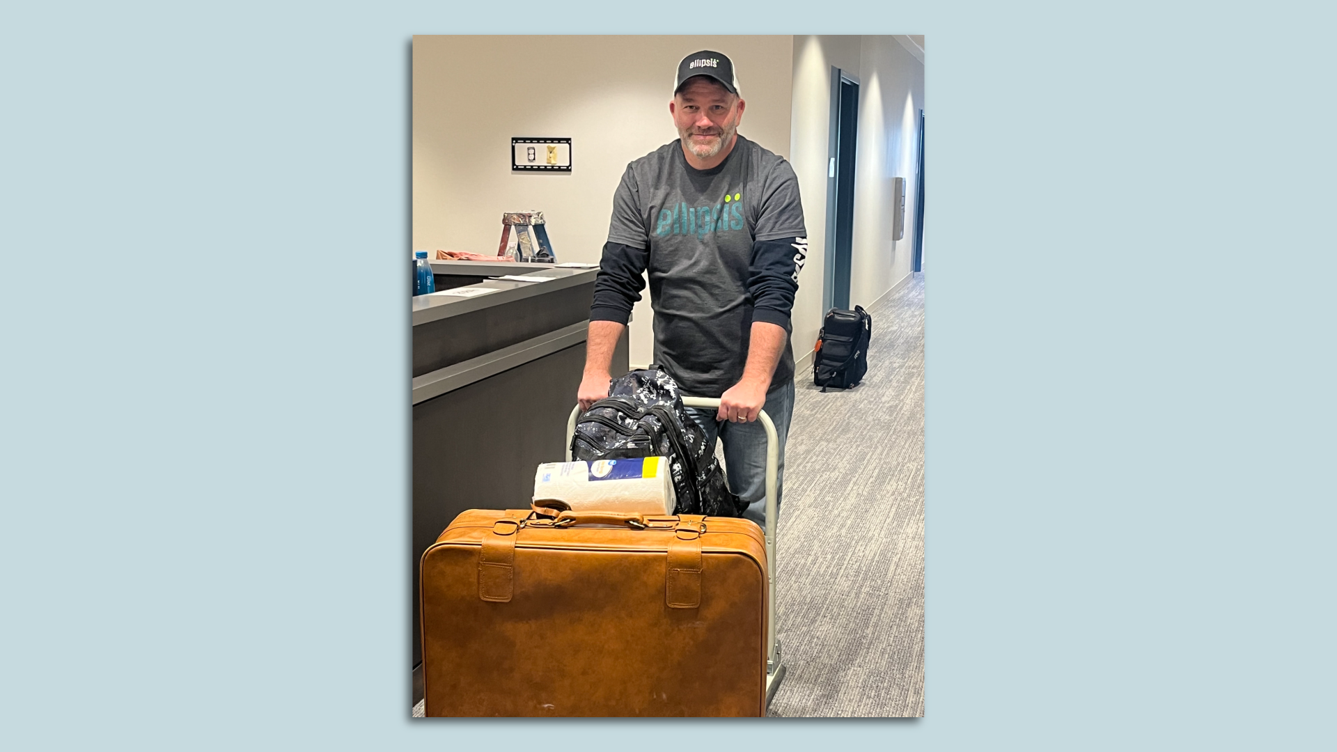 An Ellipsis worker helping at risk teens move by pushing bags