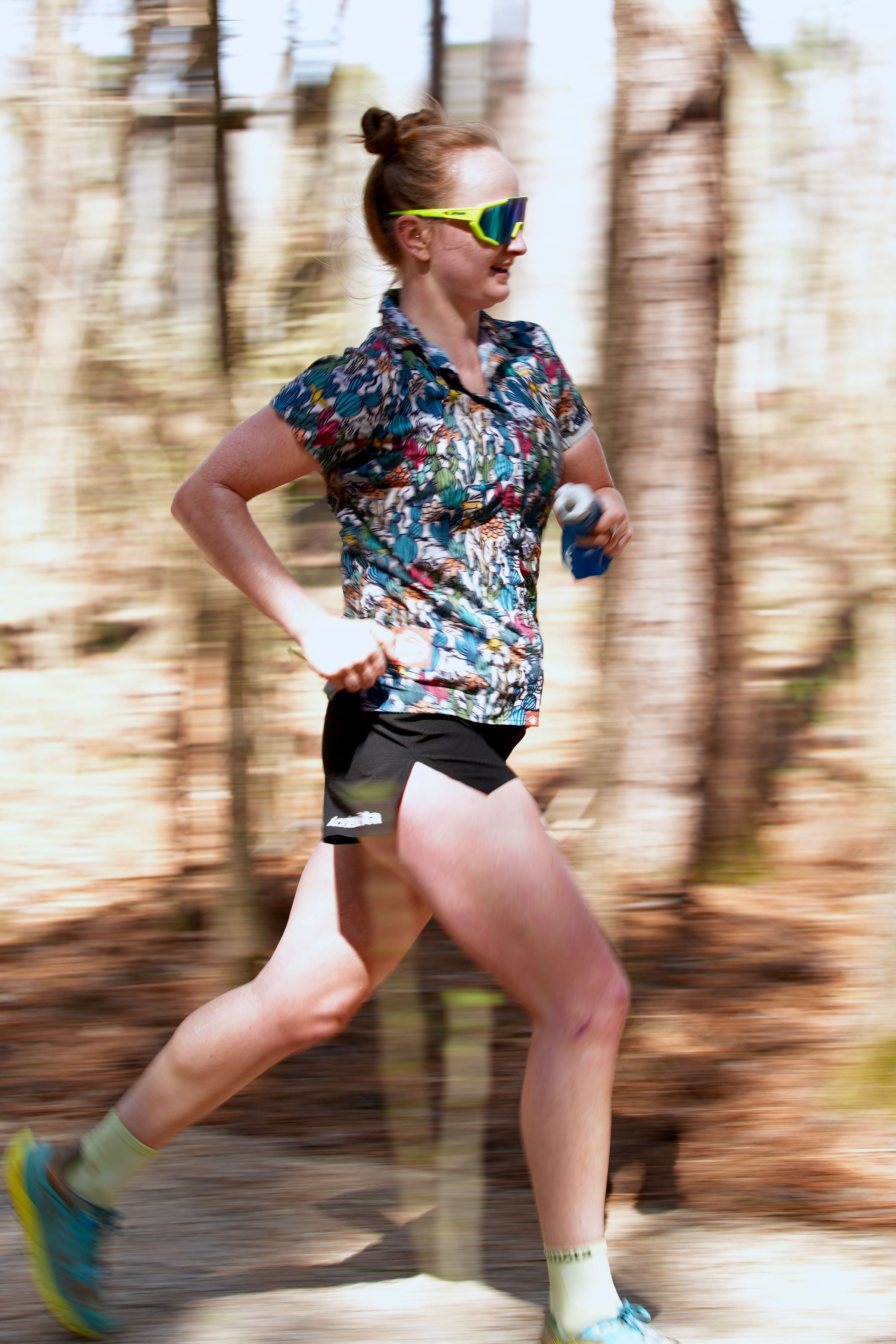 Rachel Doxey running through the woods.