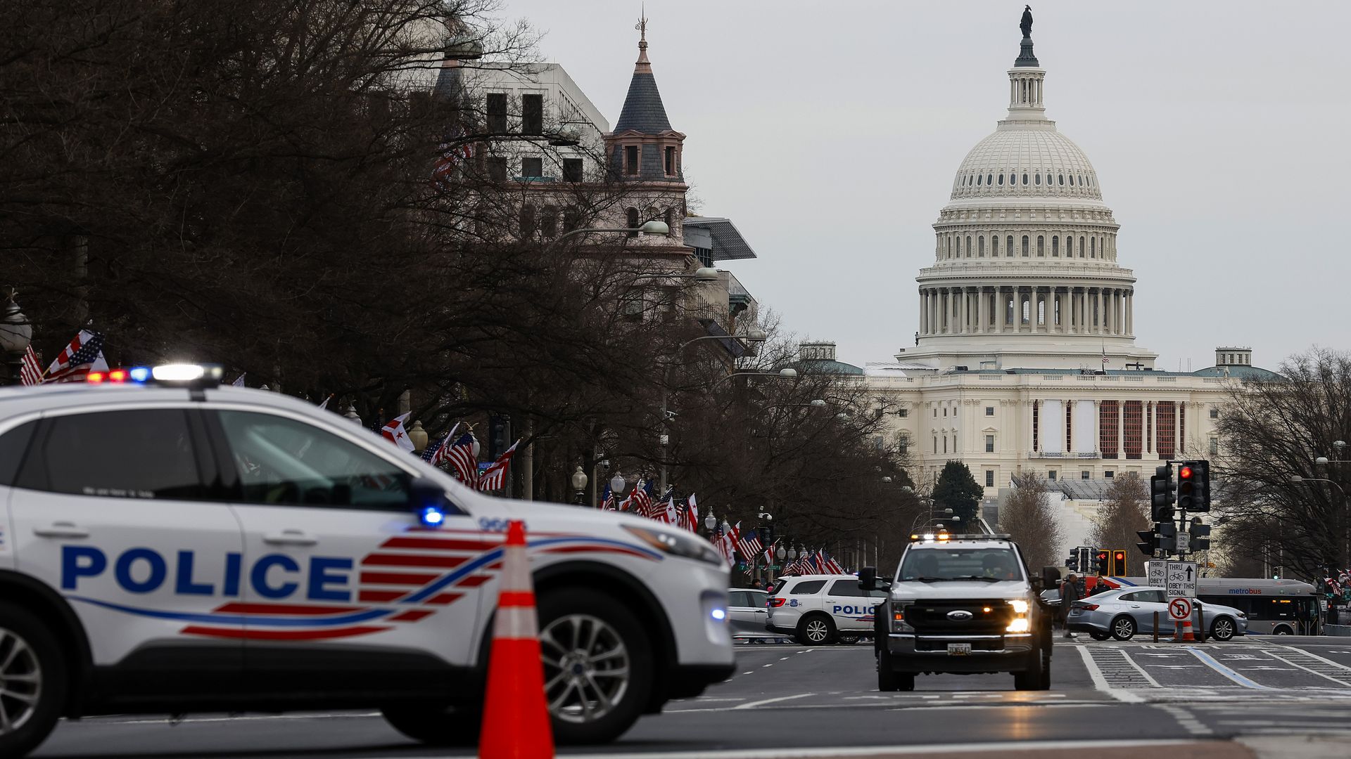 Police cars on Pennsylvania Avenue in front of the Capitol building 